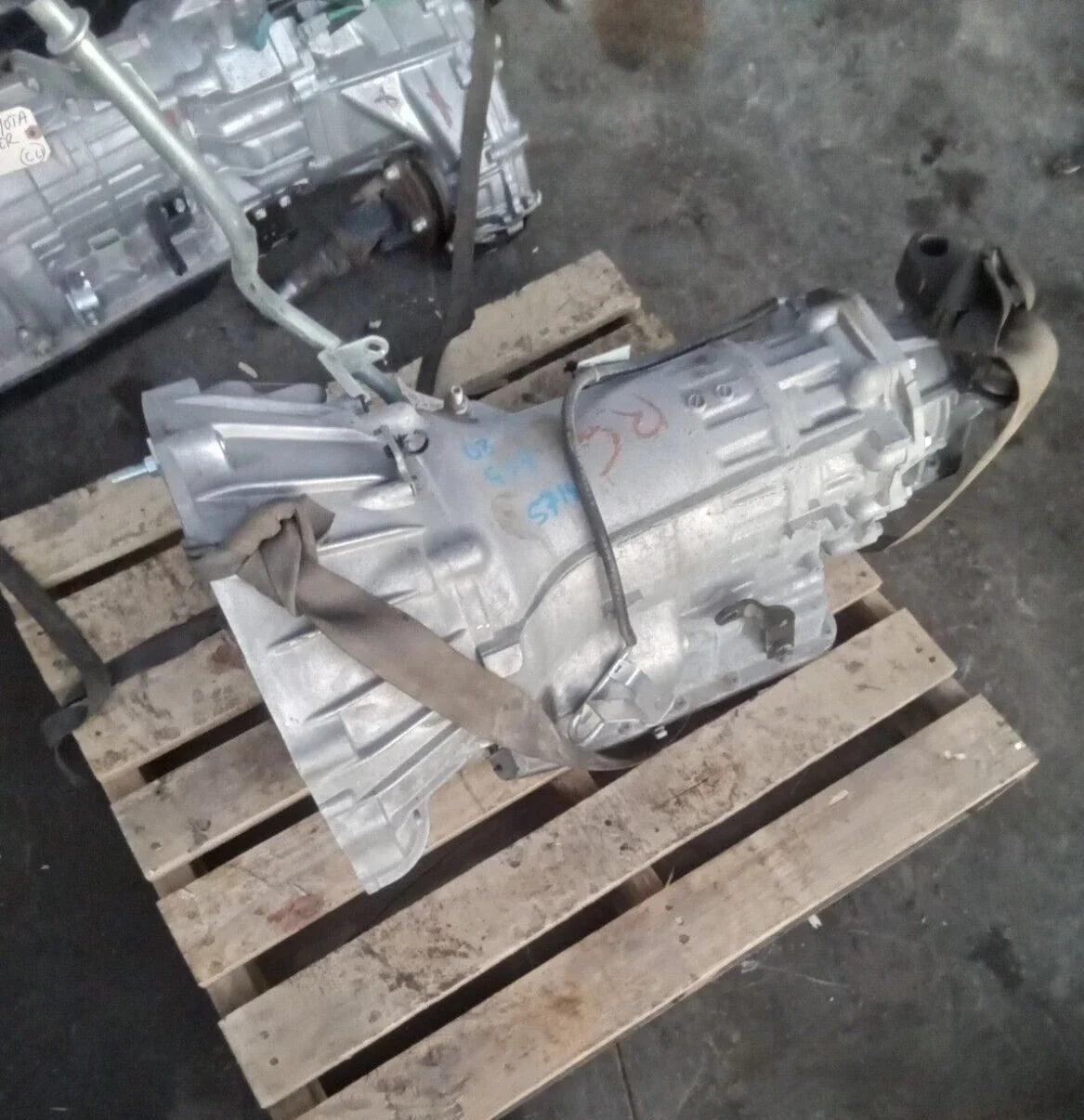 2008 Infiniti G37 automatic transmission assembly on wooden pallet with 57,753 miles