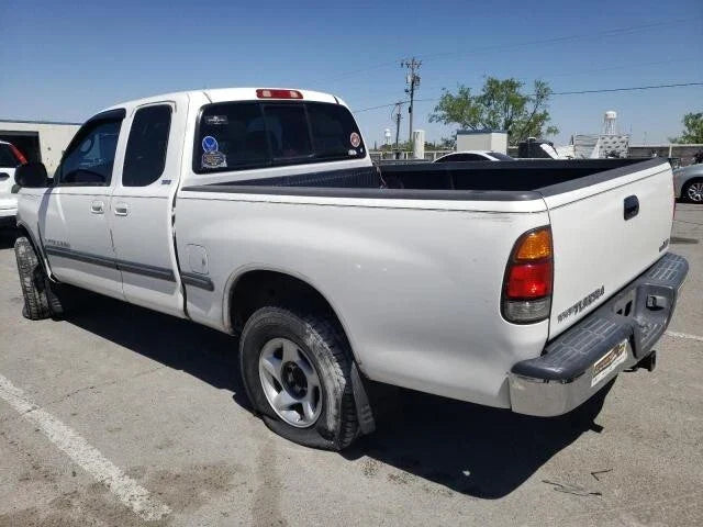 White Toyota Tundra ACC Cab pickup truck parked outdoors with extended cab and flat tire at rear passenger side
