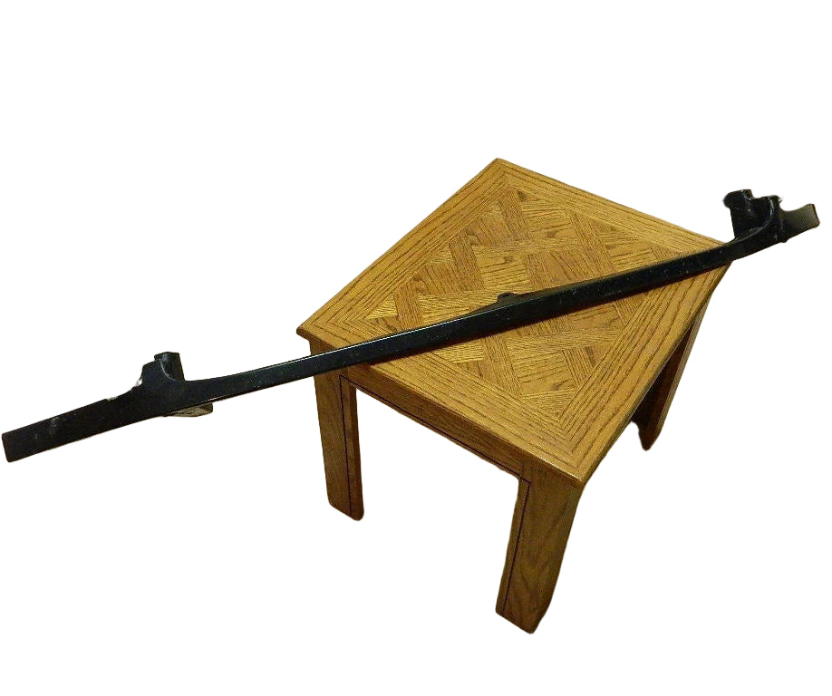 Toyota Tundra front right headlight filler OEM black plastic part on wooden table in kitchen setting