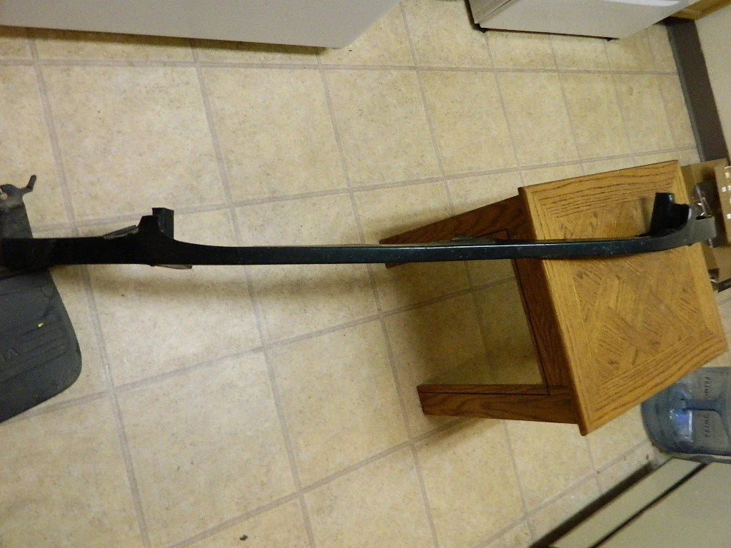 TOYOTA TUNDRA front right headlight filler OEM part lying on tiled floor next to wooden table